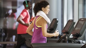 A woman running on a treadmill in a gym with another person in the background. - Hyatt Regency O'Hare Chicago (Rosemont)