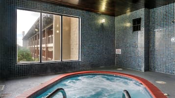 Relax by the indoor pool with a view of the surrounding building.