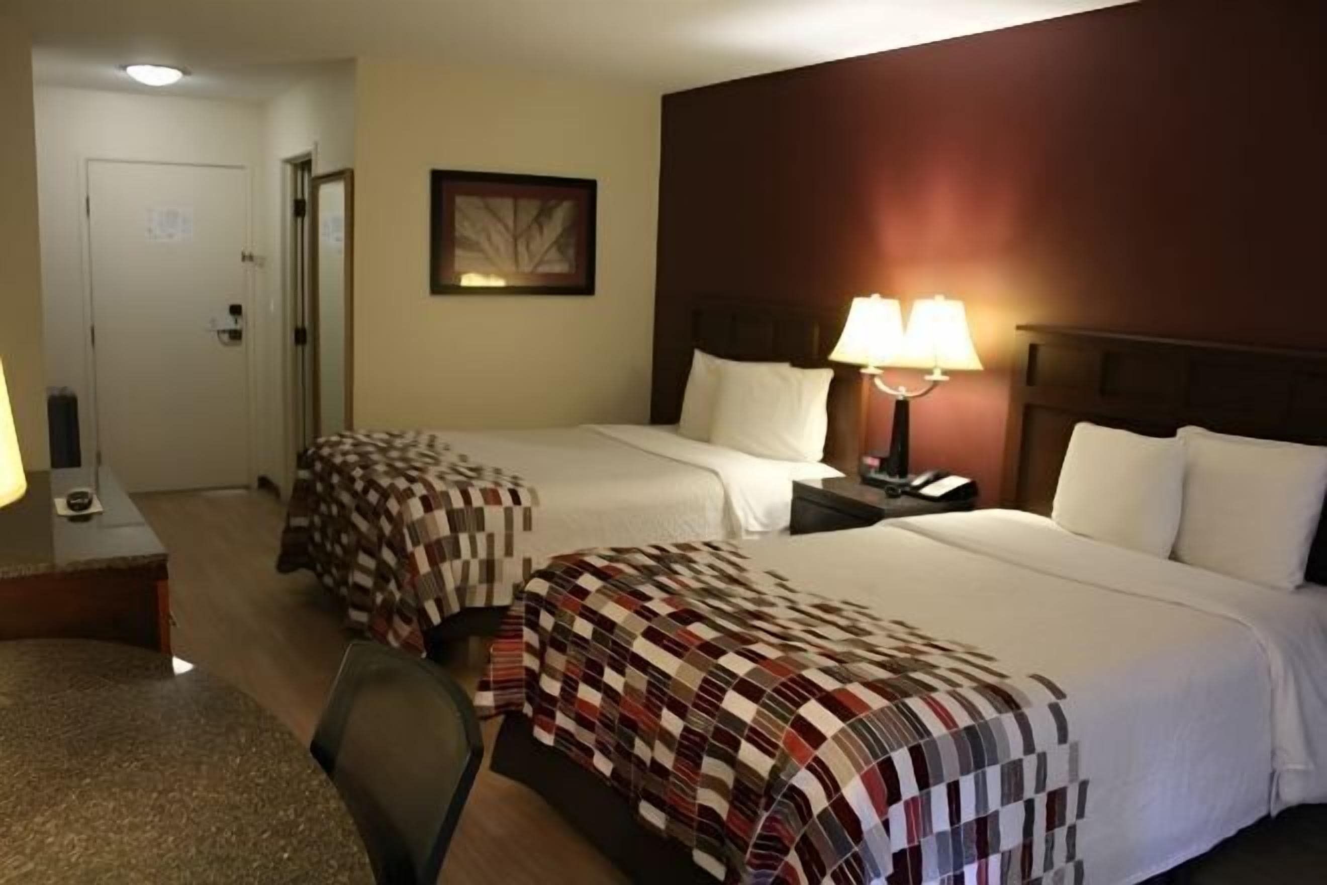 Desk, laptop workspace, iron/ironing board, free cribs/infant beds