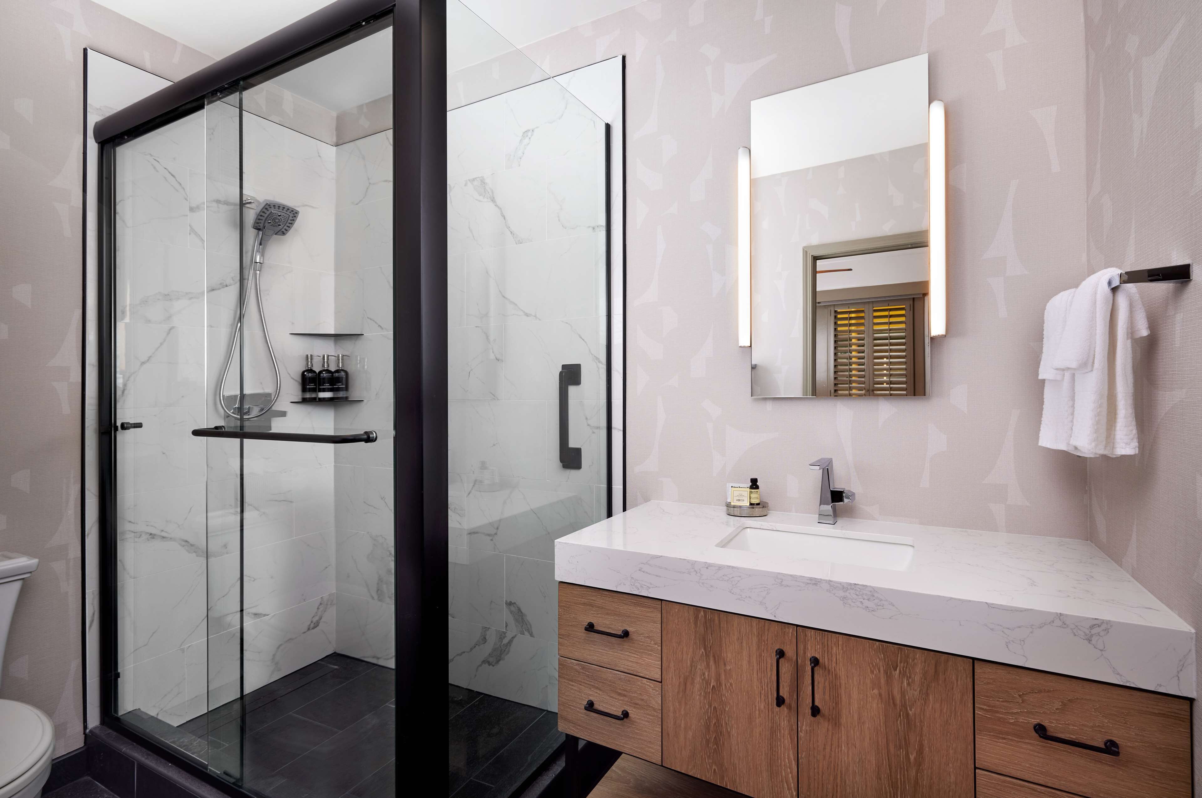 deluxe room, 1 king bed | bathroom | combined shower/bathtub, designer toiletries, hair dryer, towels