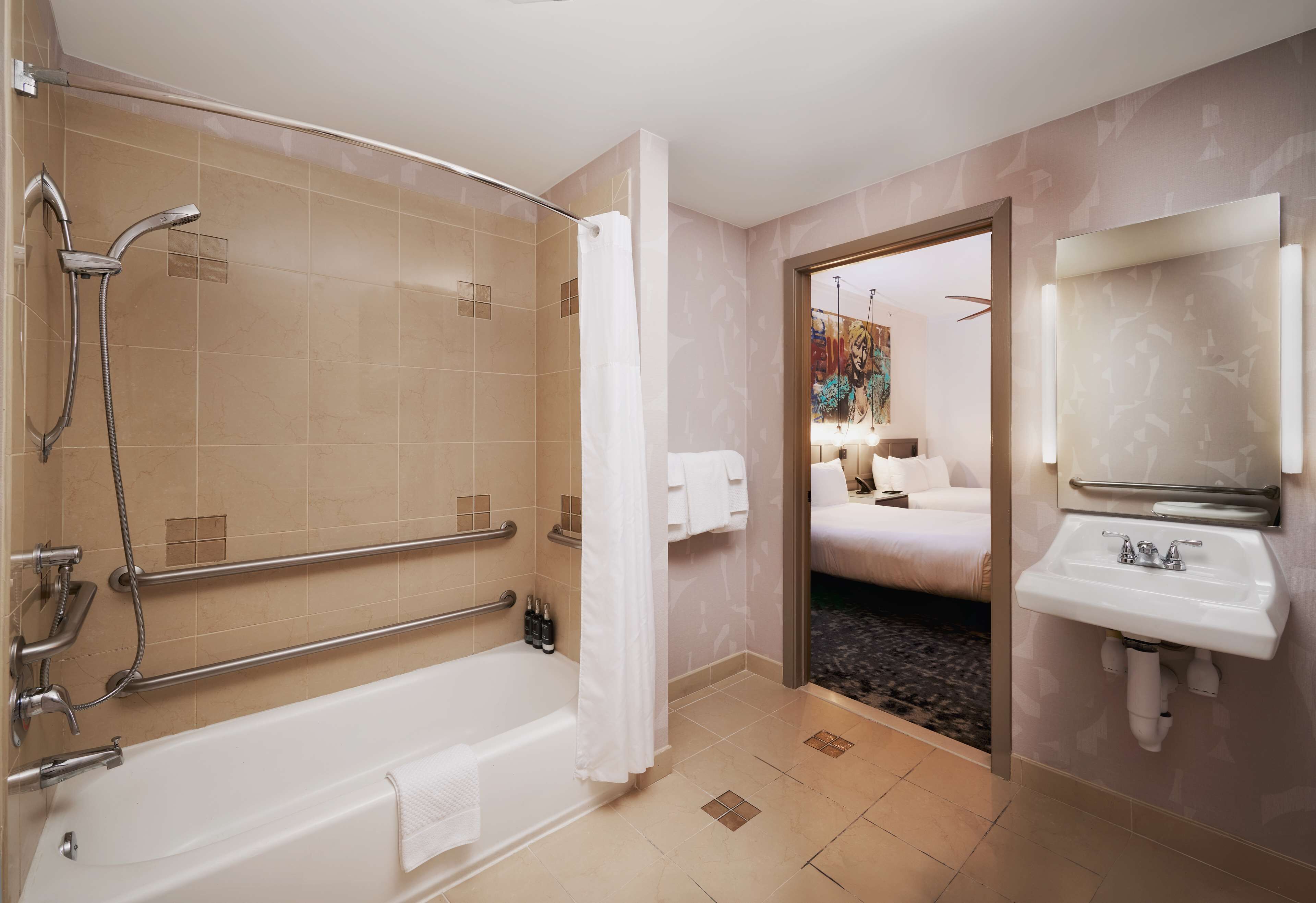 combined shower/bathtub, designer toiletries, hair dryer, towels