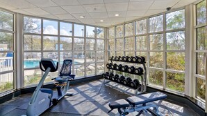A gym with exercise equipment, a bench, and a rack of dumbbells. - Hampton Inn Mobile-East Bay/Daphne (Daphne)