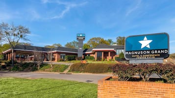 Experience the charm of this hotel, featuring a traditional brick facade and covered parking area.