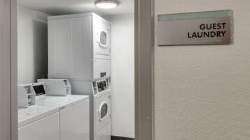 A laundry area with a sign reading "GUEST LAUNDRY".