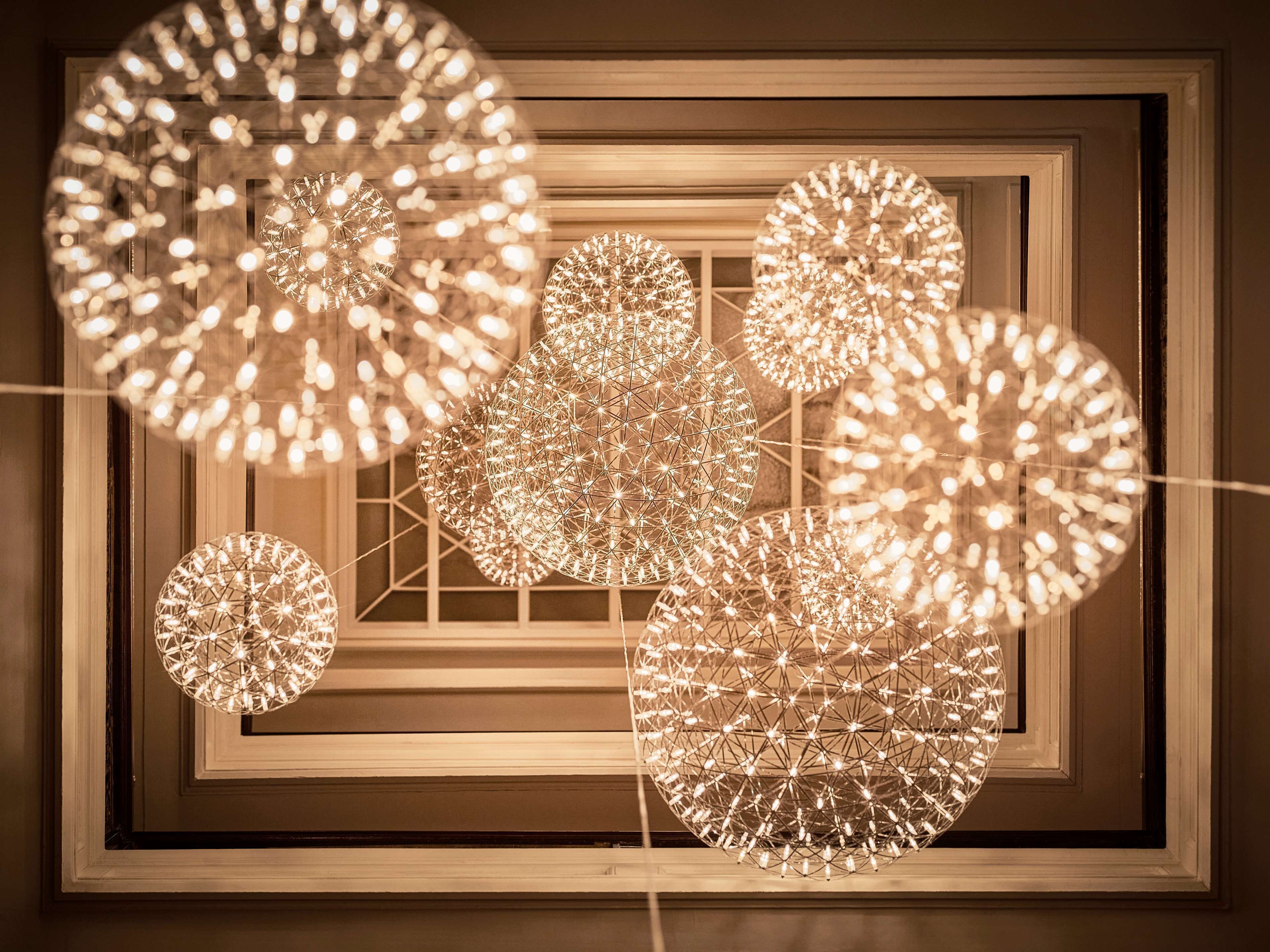 A geometric light installation with multiple spherical structures.