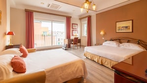 A hotel room with two beds, a desk, a chair, a balcony, and a chandelier. - Best Western Hotel Rivoli (Rome)