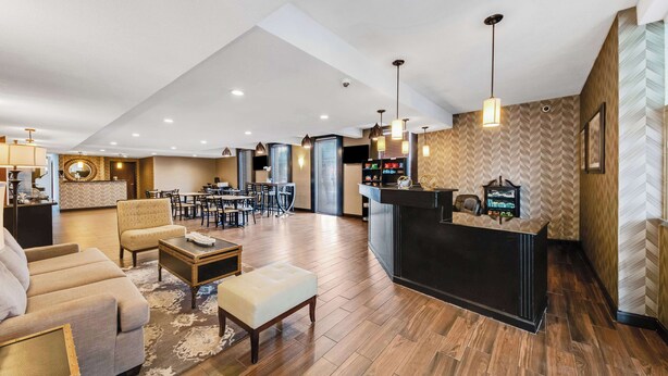A spacious lobby with a reception desk, seating area, and a dining setup. - Best Western Inn of Del Rio (Del Rio)