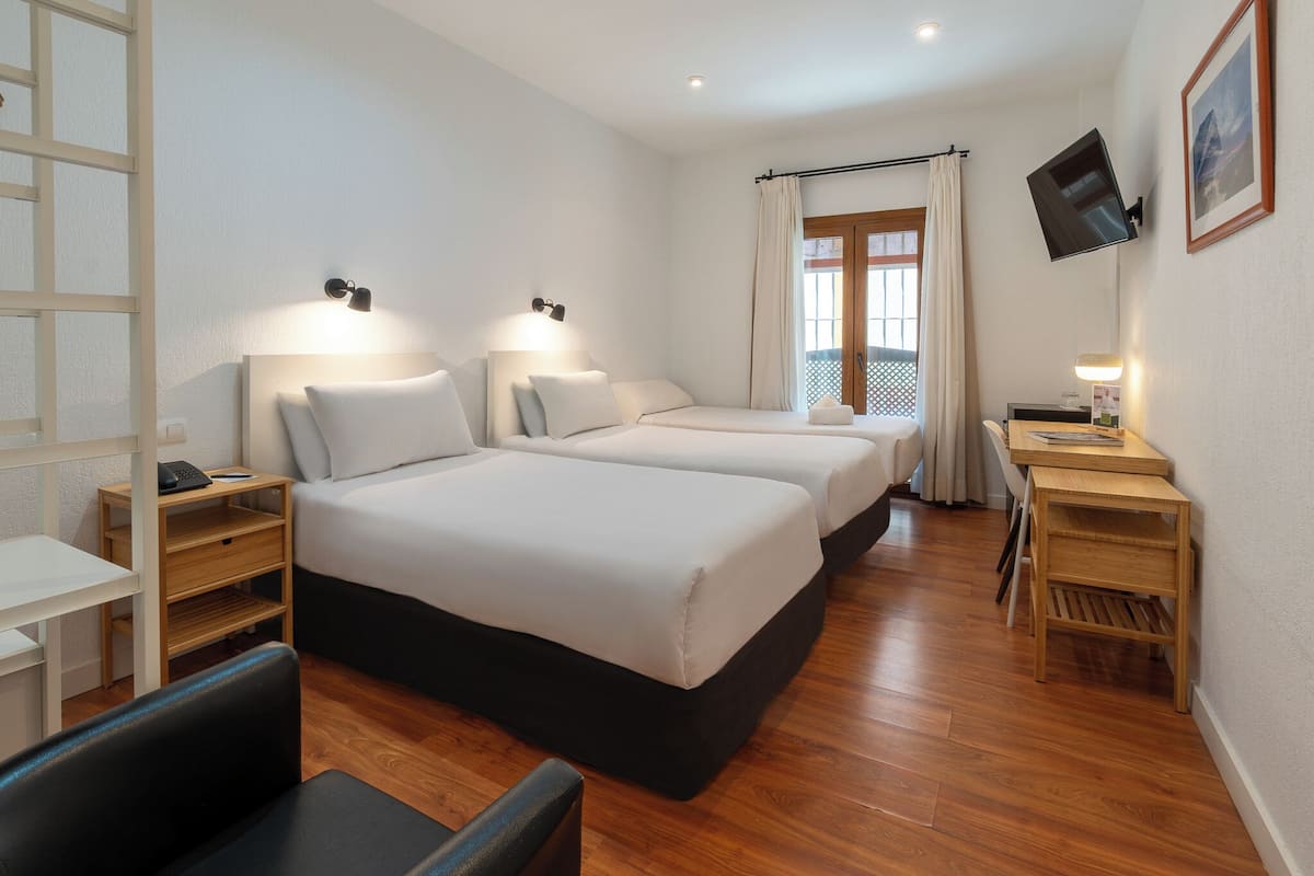 Standard Triple Room | Minibar, in-room safe, desk, soundproofing