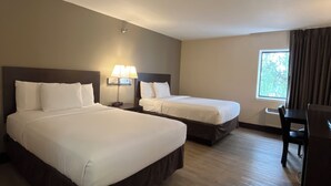 A hotel room with two beds, a desk, and a window with curtains. - Quality Inn Wilkes-Barre near Arena (Wilkes-Barre)
