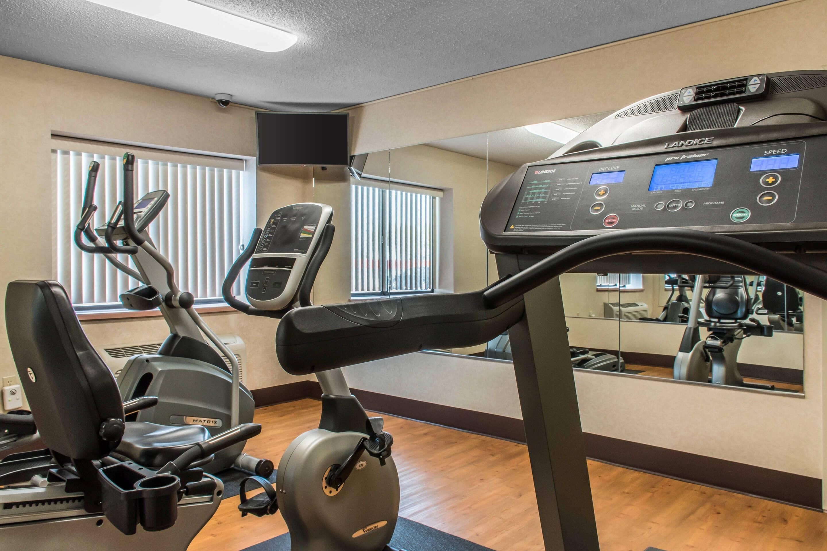 Ein Fitnessraum mit Laufband, Ergometer und Crosstrainer.