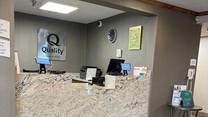 A hotel reception area with a marble counter, a clock, and a welcome mat. - Quality Inn Wilkes-Barre near Arena (Wilkes-Barre)