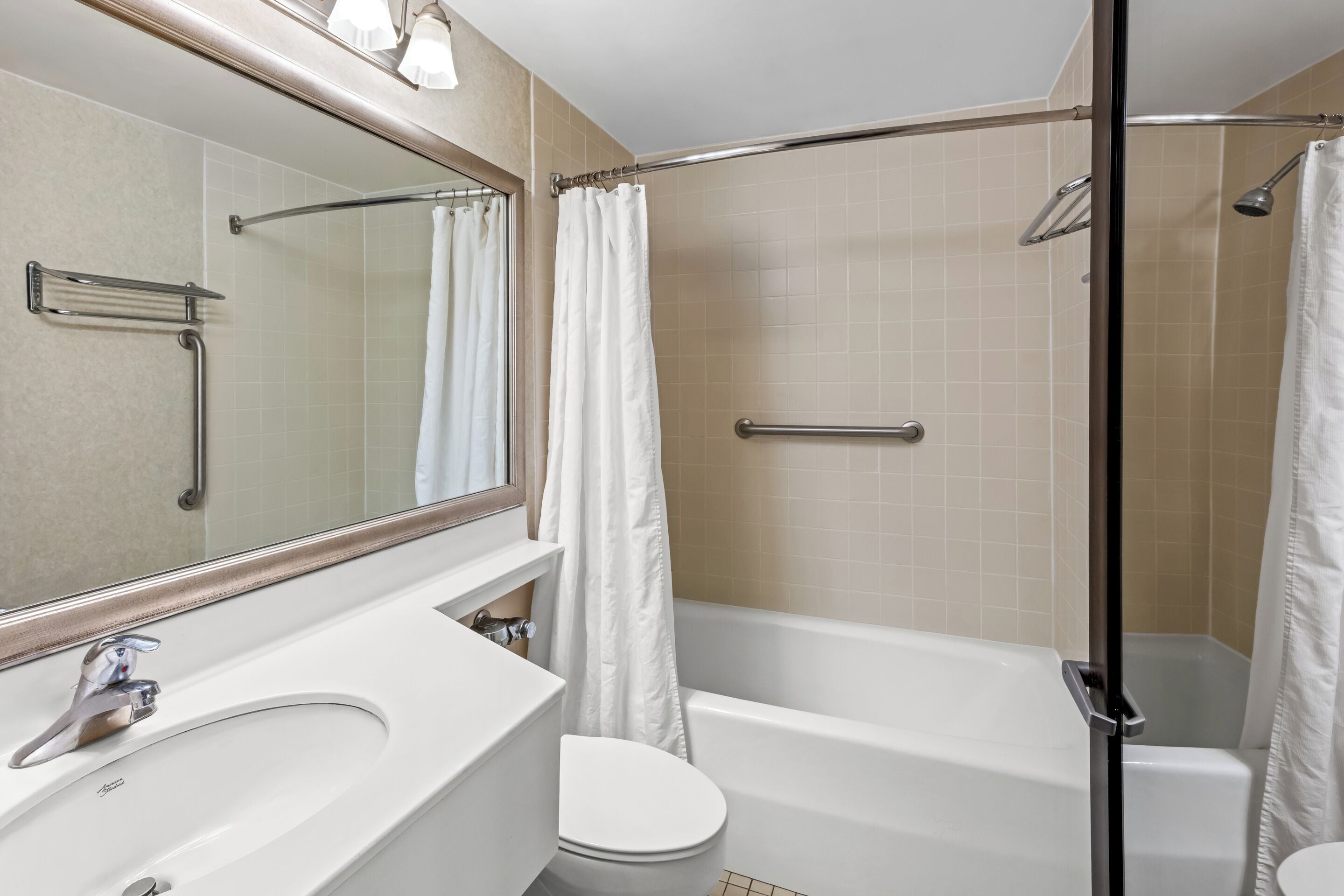A bathroom with a sink, toilet, and bathtub.