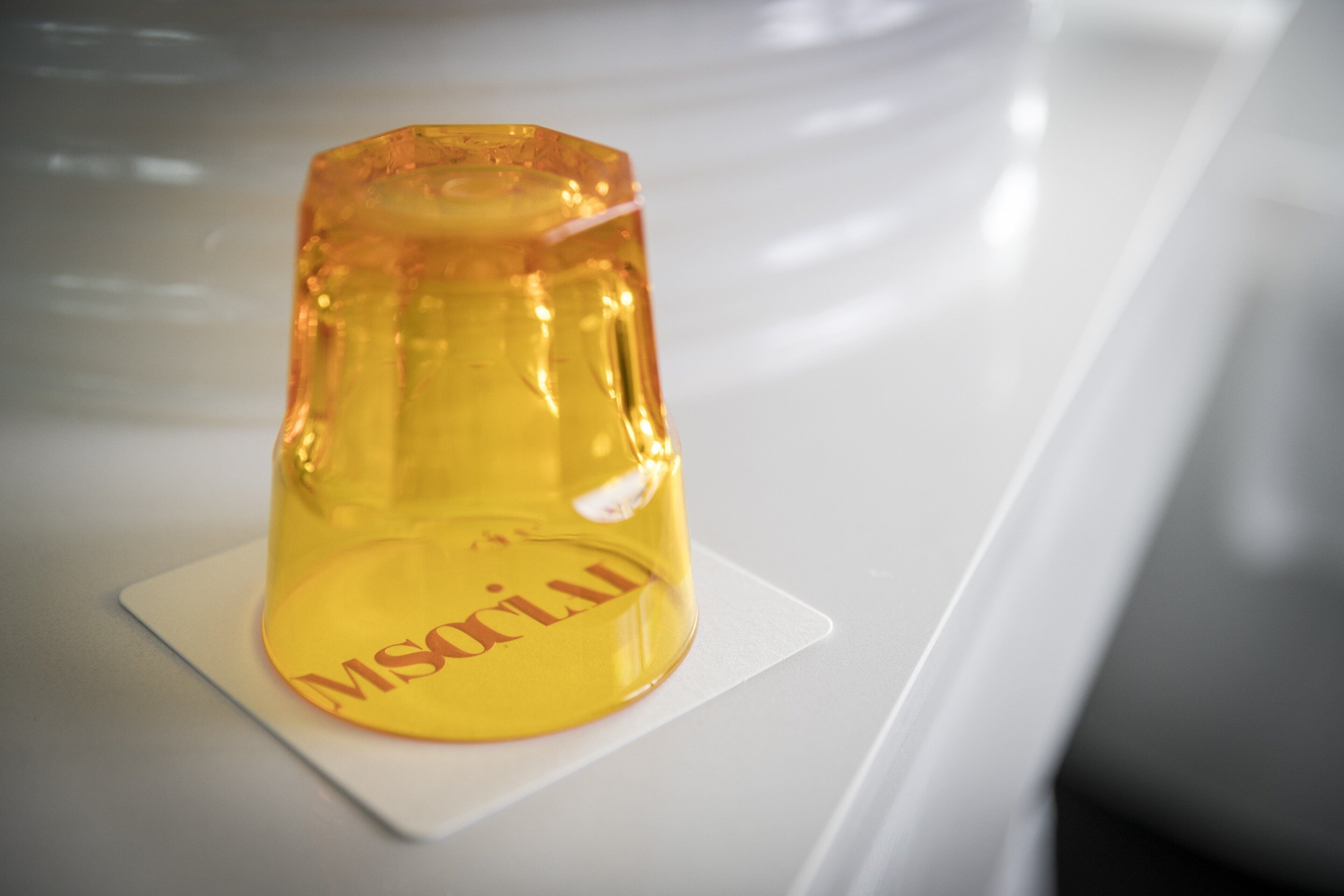 A yellow object with the text "MSRILU" on a white surface.