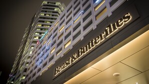 A high-rise hotel with illuminated signage reading "Beast & Butterflies." - M Social Hotel Auckland (Auckland)