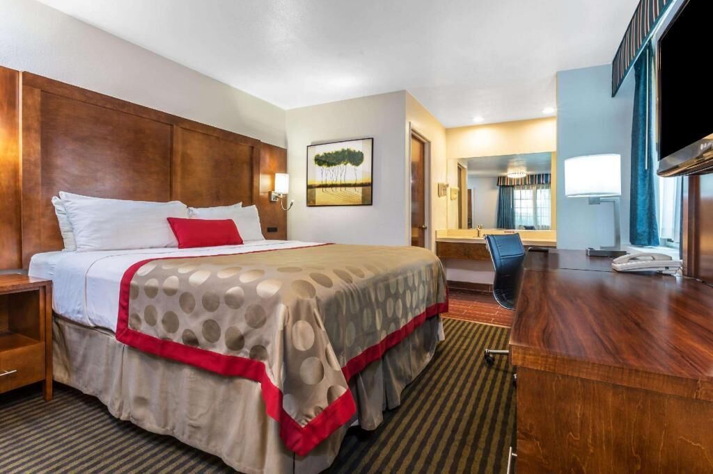 Premium bedding, desk, laptop workspace, blackout drapes