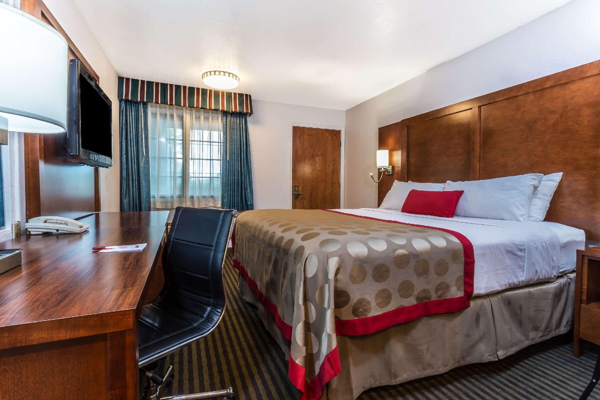 Premium bedding, desk, laptop workspace, blackout drapes
