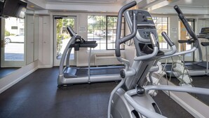 A gym with treadmills, elliptical machines, and a mirrored wall. - Ramada by Wyndham Mountain View (Mountain View)