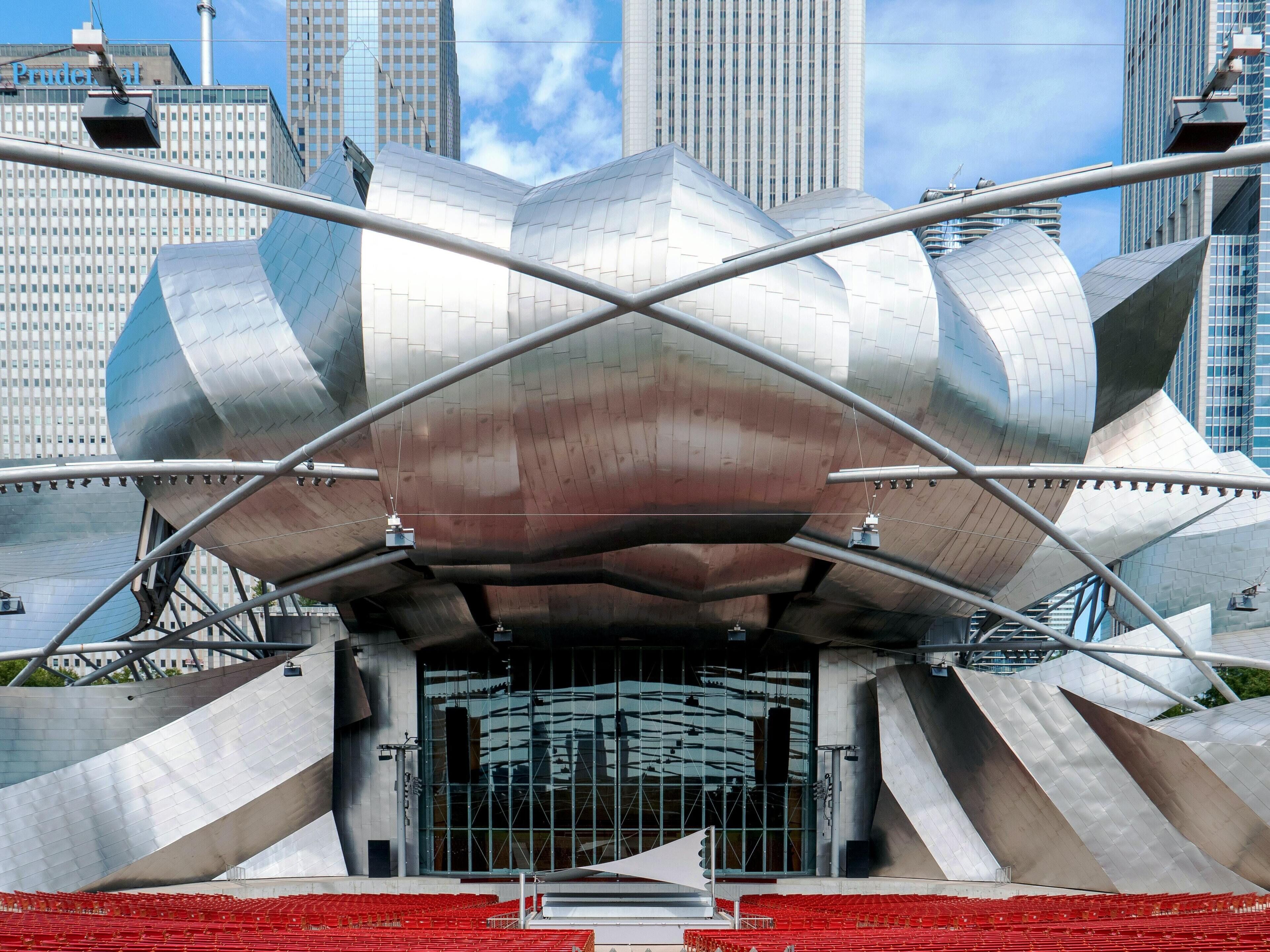 A modern architectural structure with a unique, metallic design and a large entrance.