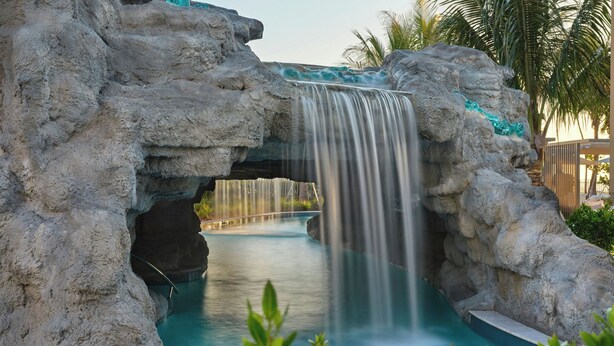 A rock formation with a waterfall and a pool. - The St. Regis Longboat Key Resort (Longboat Key)