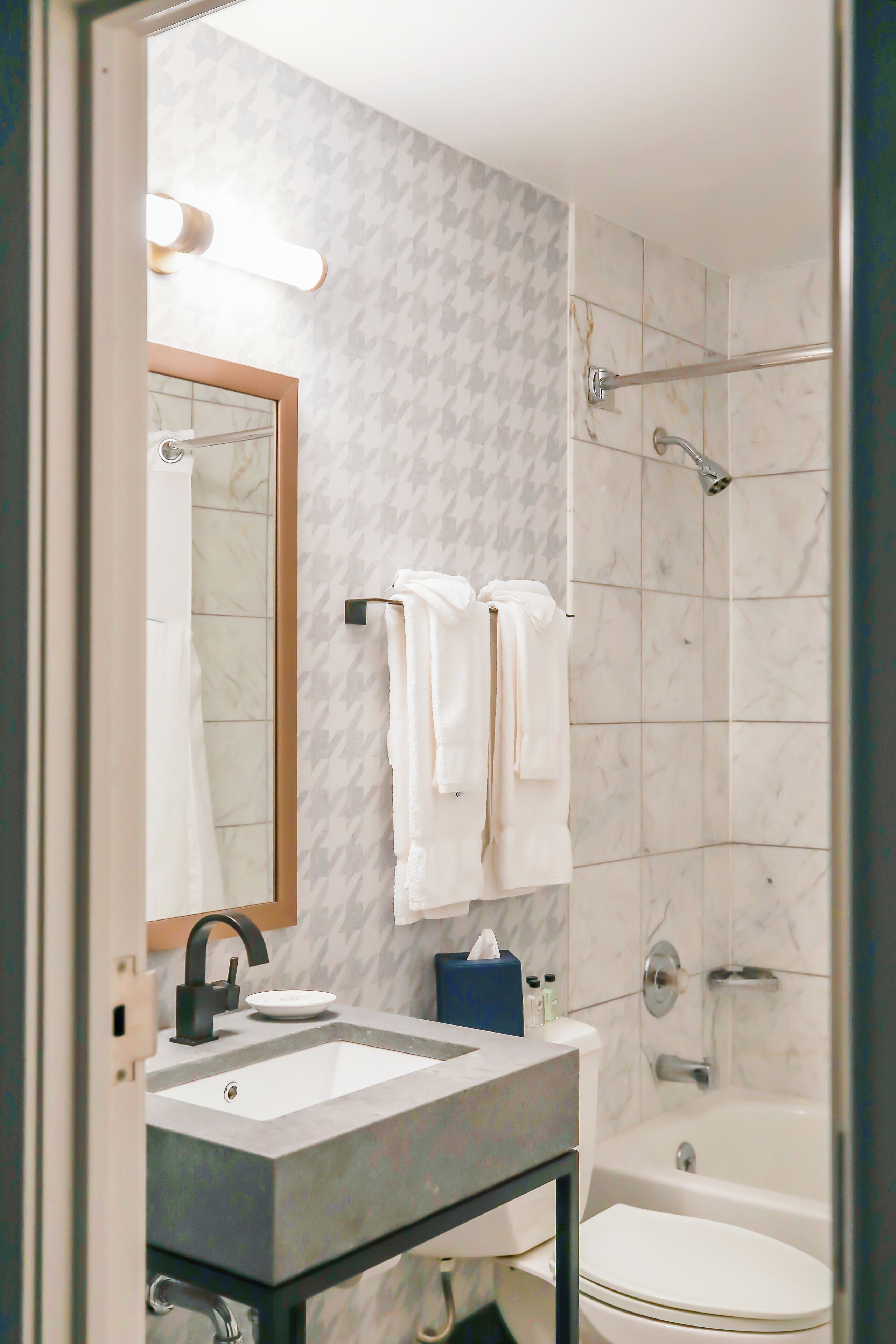 combined shower/bathtub, designer toiletries, hair dryer, bathrobes
