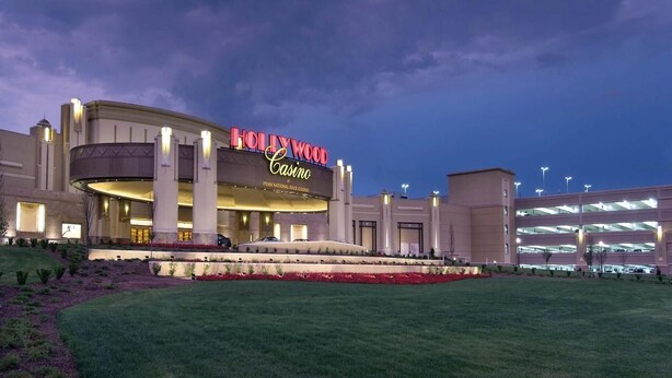 A large, modern building with a prominent casino sign, multiple levels, and a landscaped entrance area.