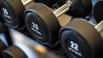 A close-up of a set of dumbbells with weight markings.