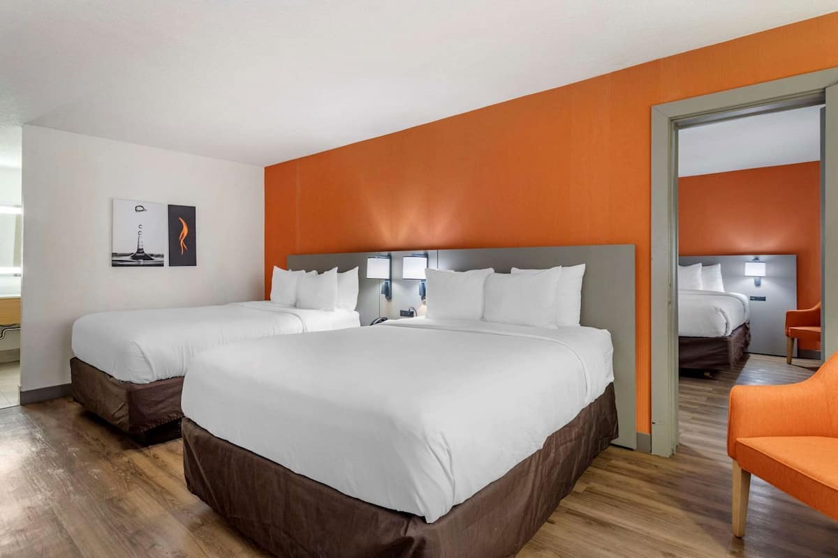 Hypo-allergenic bedding, desk, laptop workspace, blackout drapes