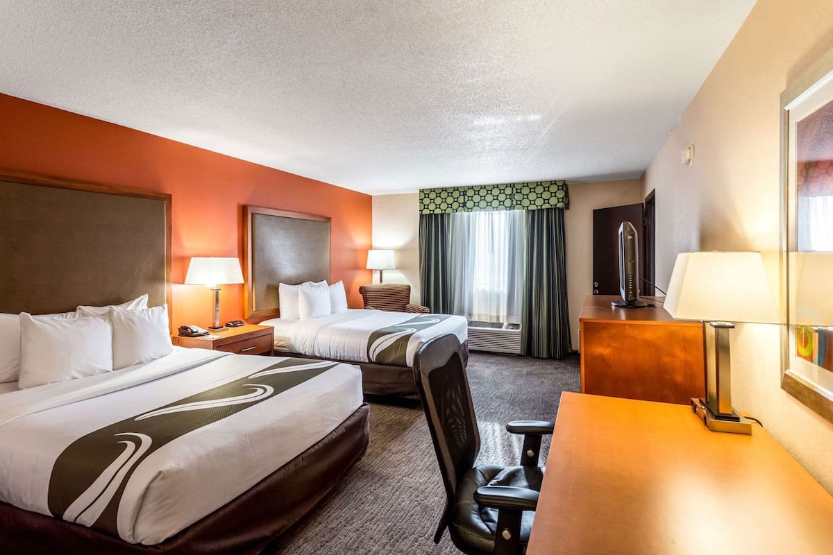Hypo-allergenic bedding, desk, laptop workspace, blackout drapes