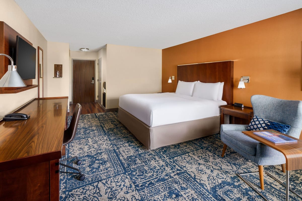 Premium bedding, desk, laptop workspace, iron/ironing board