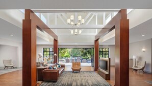 A spacious living area with a large TV, comfortable seating, and a view of the outdoors.