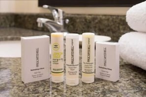 A bathroom counter with five toiletries: Refreshing Citrus body wash, Lemon Sage body wash, Super Rich Wash shampoo, The Detangler conditioner, and Refreshing Citrus facial cleanser. - Four Points by Sheraton Pleasanton (Pleasanton)