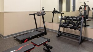 A gym with treadmills, a bench, and a rack of dumbbells. - Baymont by Wyndham Festus (Festus)