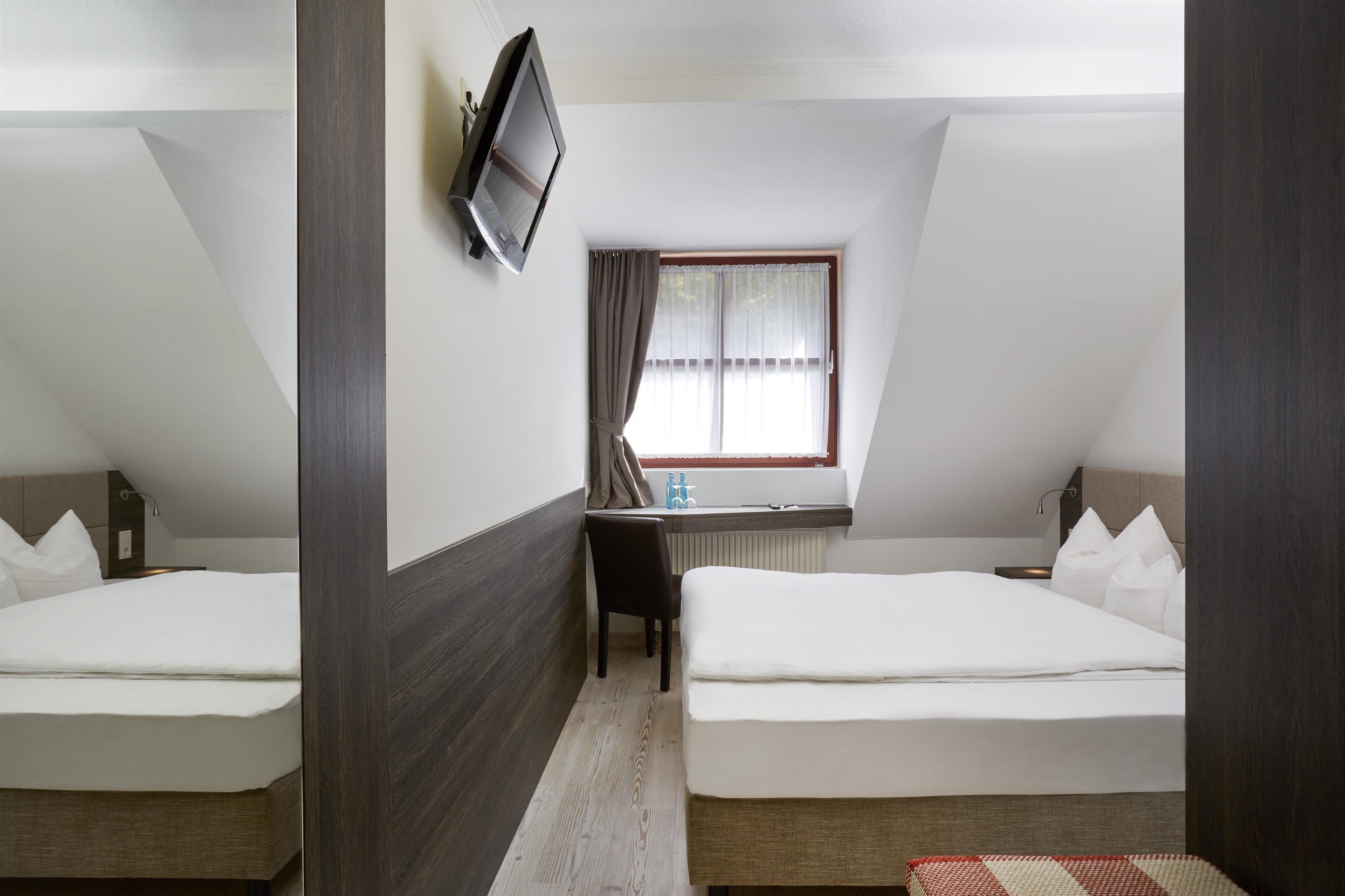 premium bedding, pillow-top beds, desk, laptop workspace