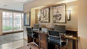 A hotel reception area with a desk, two computers, and a sign indicating computer use age restriction. - Best Western Westminster Hotel (Westminster)