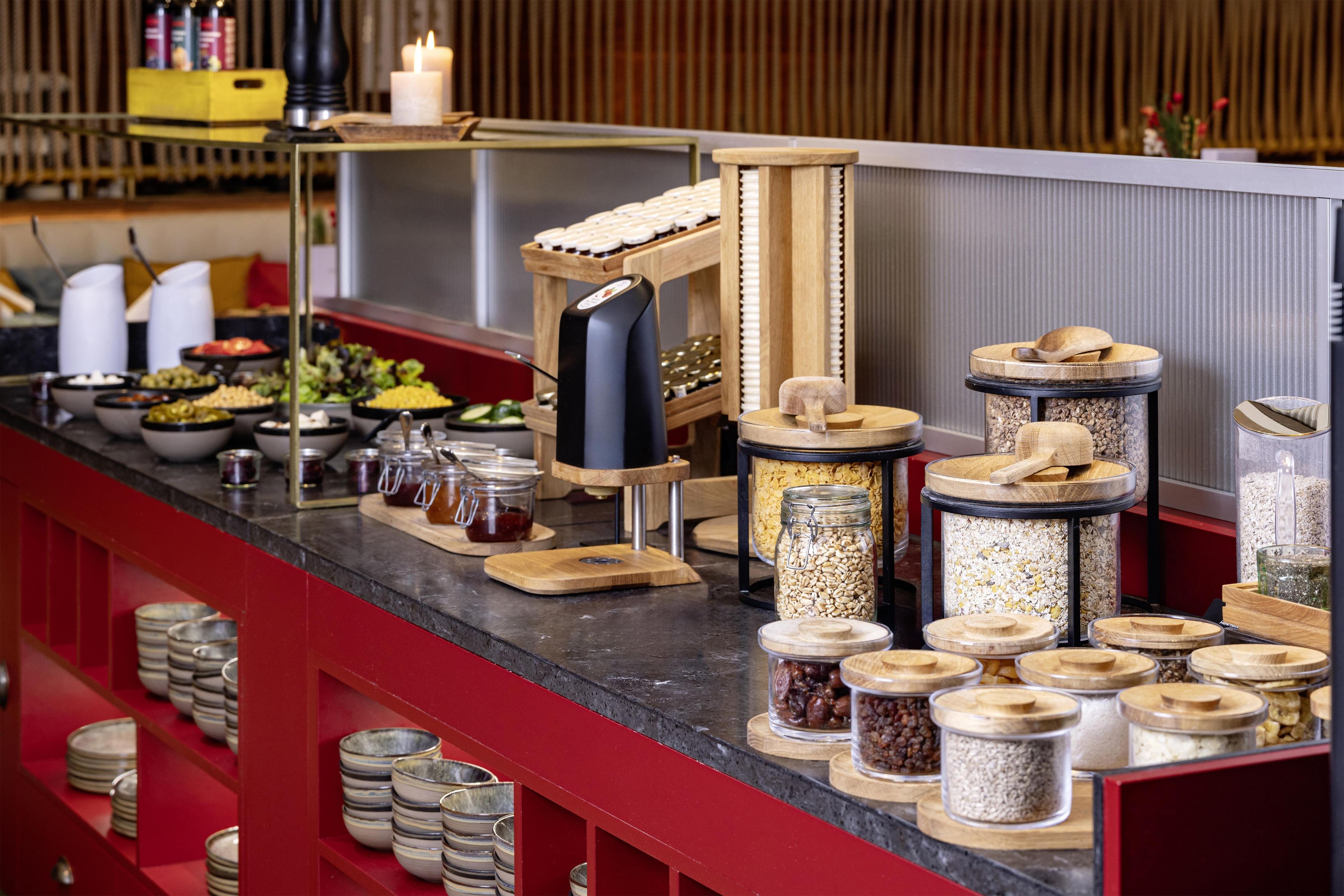 A buffet setup with various food containers and utensils.