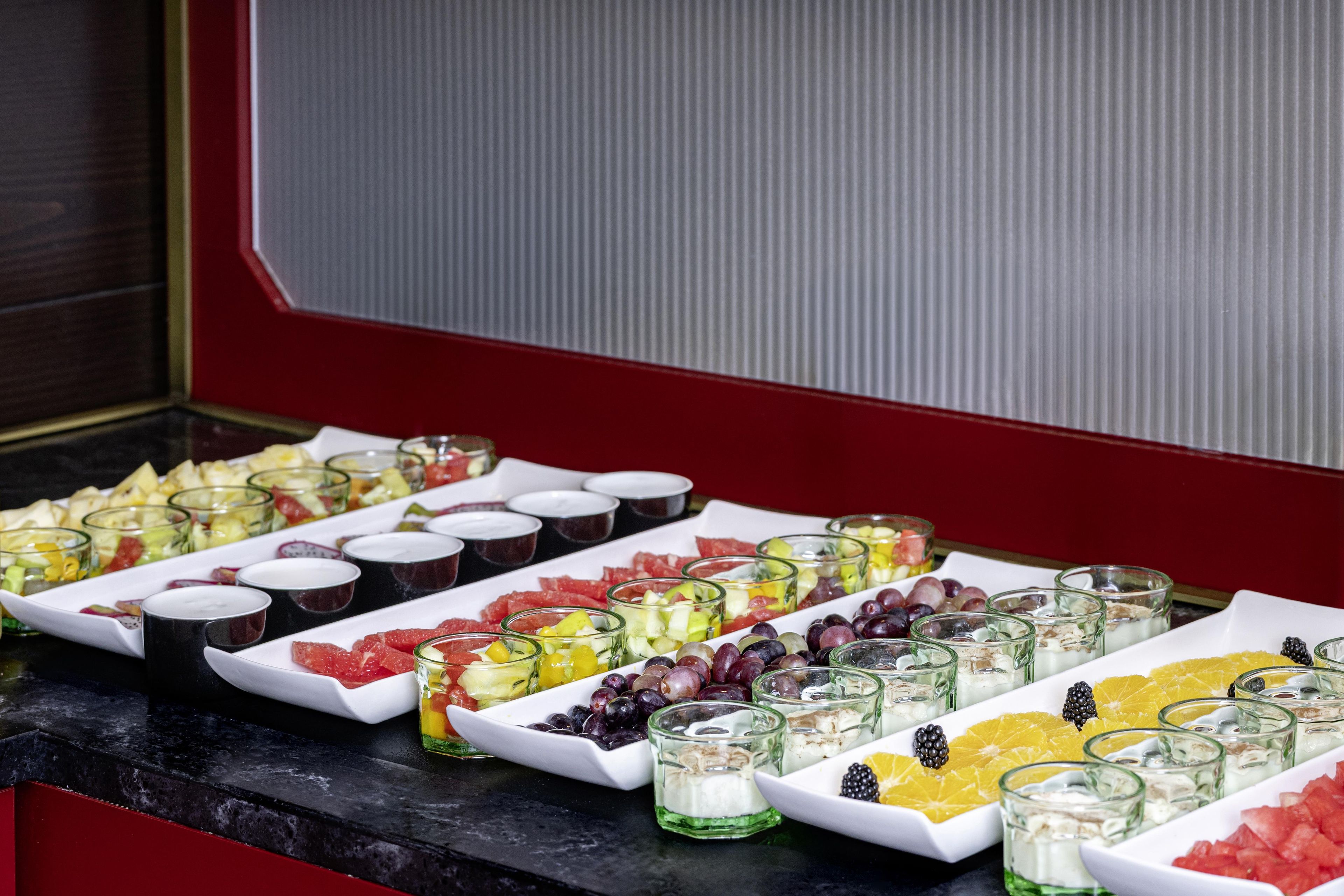 A buffet with various food items and beverages arranged on a counter.