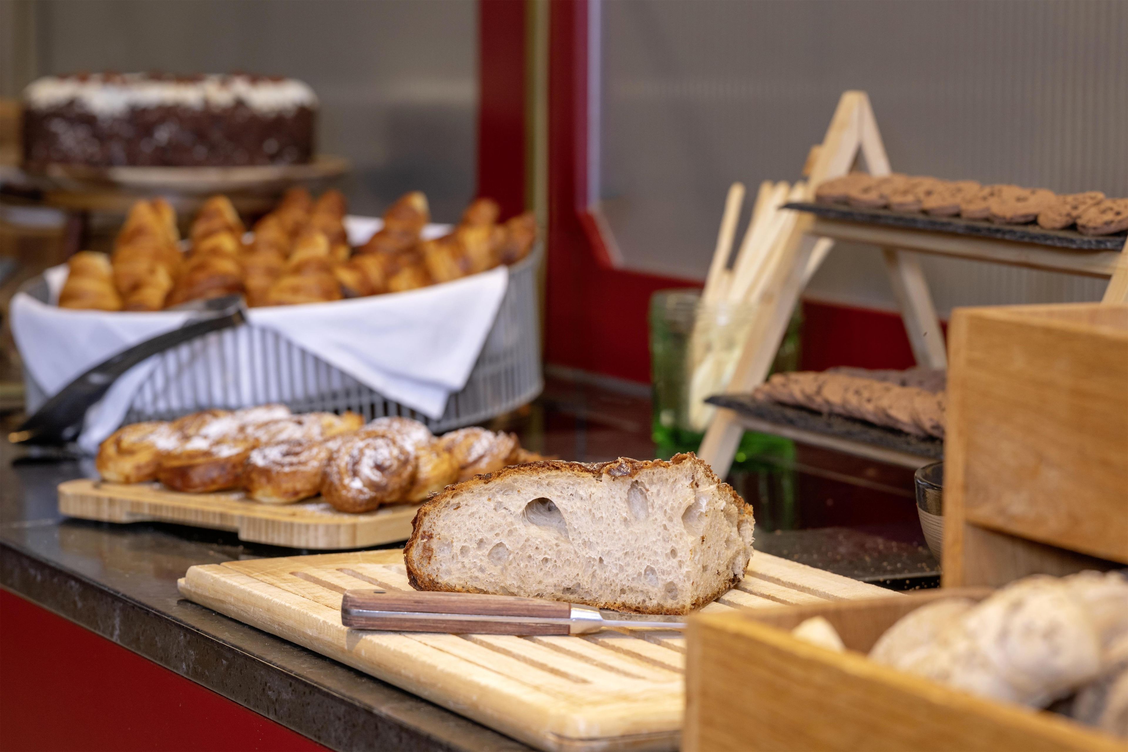 A bakery display with various baked goods including bread, pastries, and cakes.