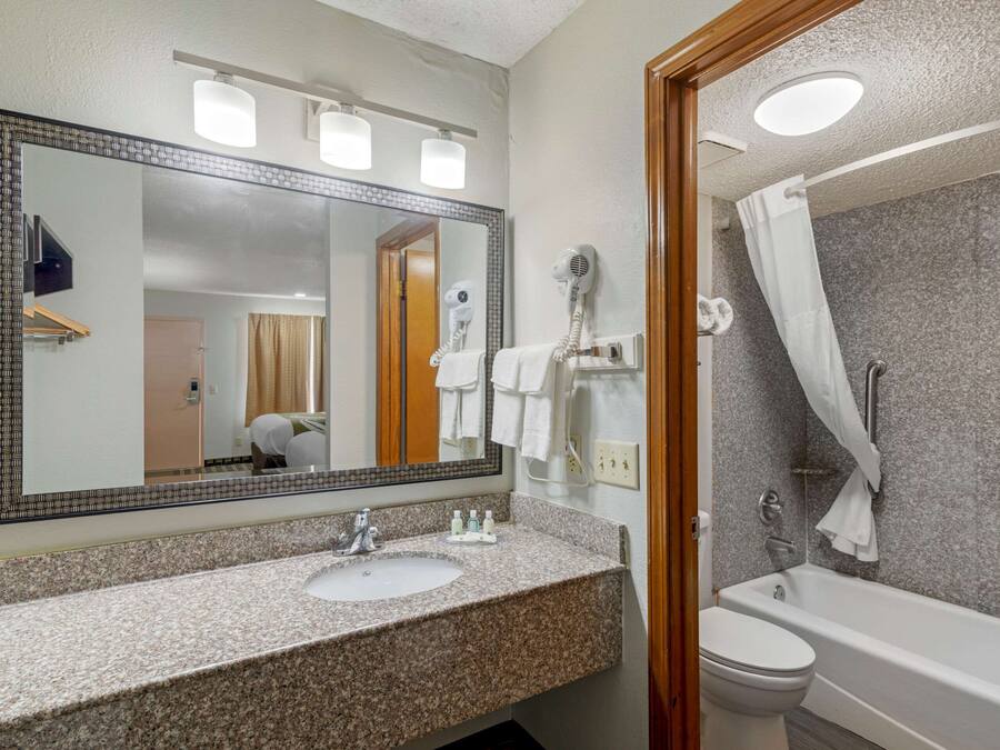 Bathtub, eco-friendly toiletries, hair dryer, towels