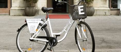 A bicycle parked in front of the Elite Grand Hotel entrance.