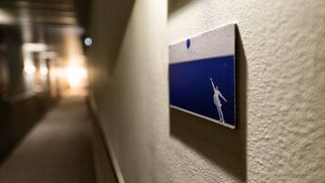A corridor with a wall-mounted sign featuring a person reaching for a star.