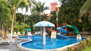 Relax by the central pool surrounded by lounge chairs and enjoy the water slides and a fun frog-shaped water feature amidst lush greenery.