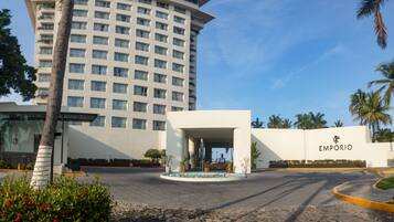 Welcome to Emporio, where a serene garden and tranquil water feature greet you at the entrance.