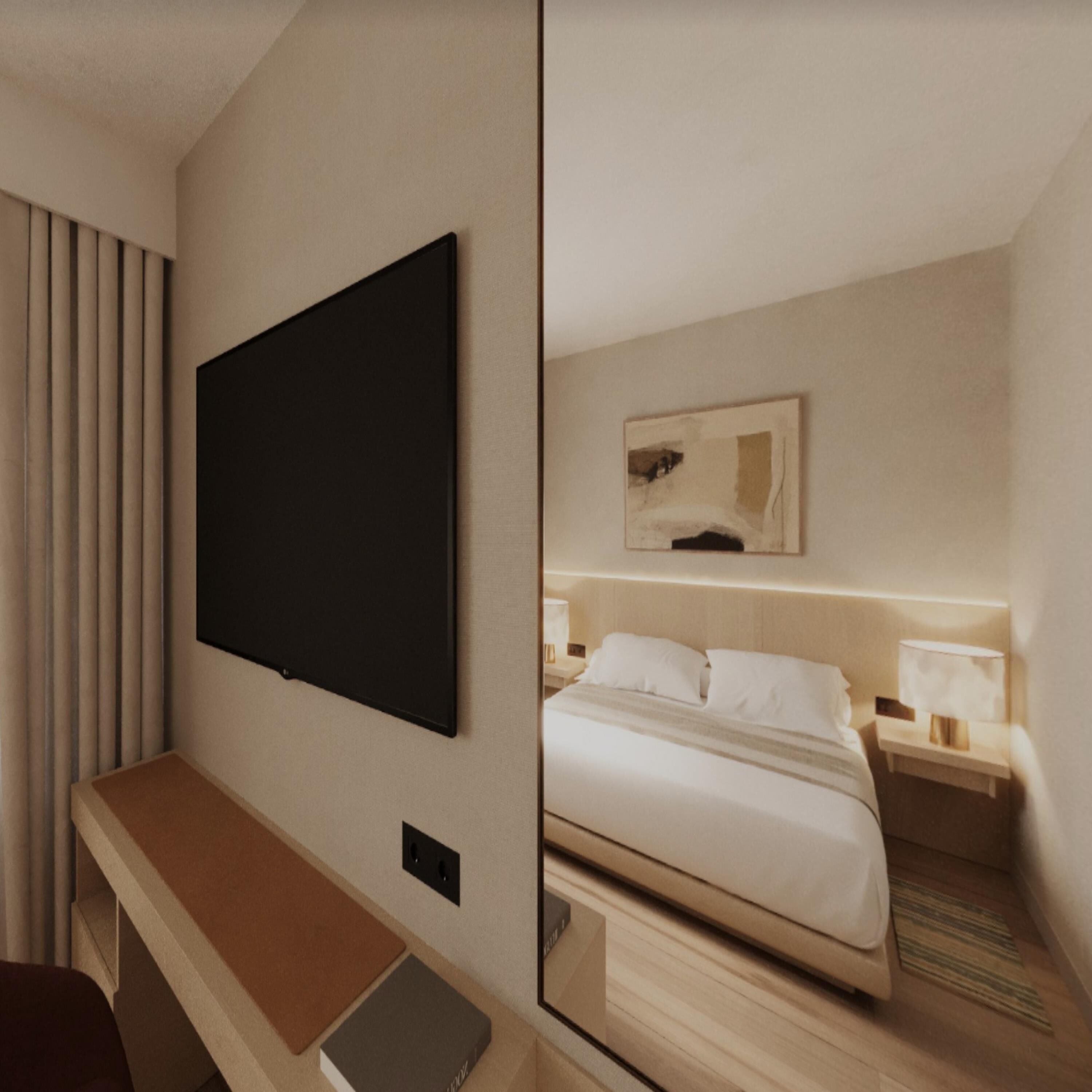 Une chambre d’hôtel dotée d’un téléviseur à écran plat fixé au mur, d’un lit avec une literie blanche, d’une table de chevet avec une lampe et d’une petite œuvre d’art au-dessus du lit.
