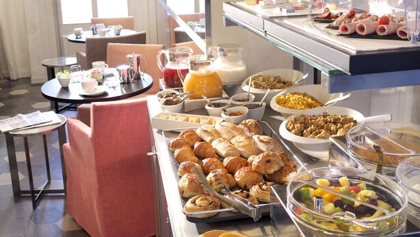 A breakfast buffet with various food items, including pastries, fruits, and beverages. - Hotel Saint Dominique (Paris)