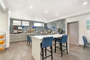 Enjoy meals and snacks at the central island with oven and range hood.