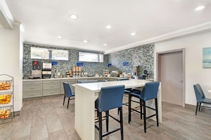 Enjoy meals and snacks at the central island with oven and range hood.