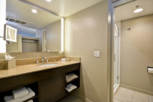 A modern bathroom with a sink, mirror, and shower. - DoubleTree by Hilton Phoenix North (Phoenix)