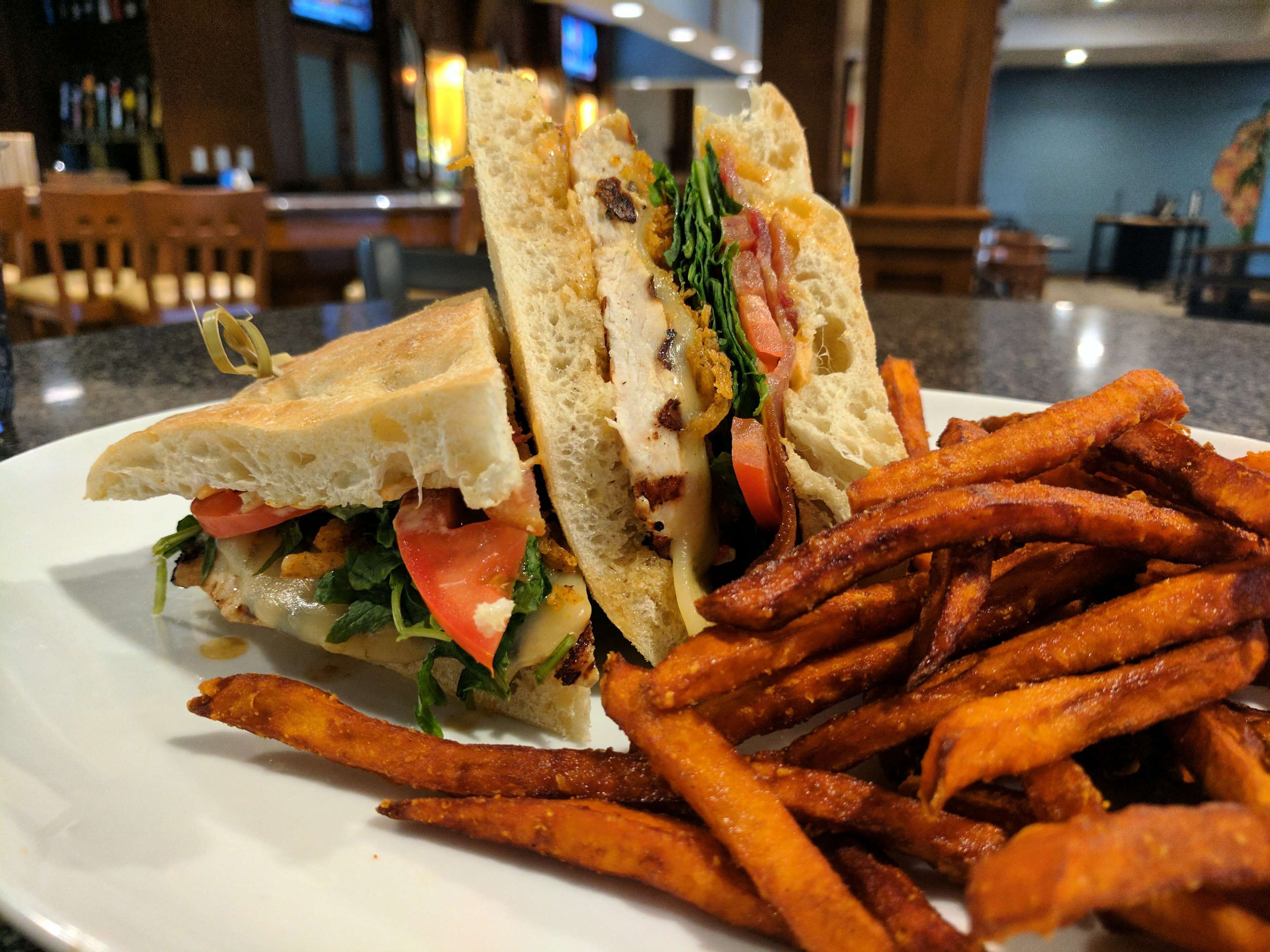 A plate with a sandwich and fries.