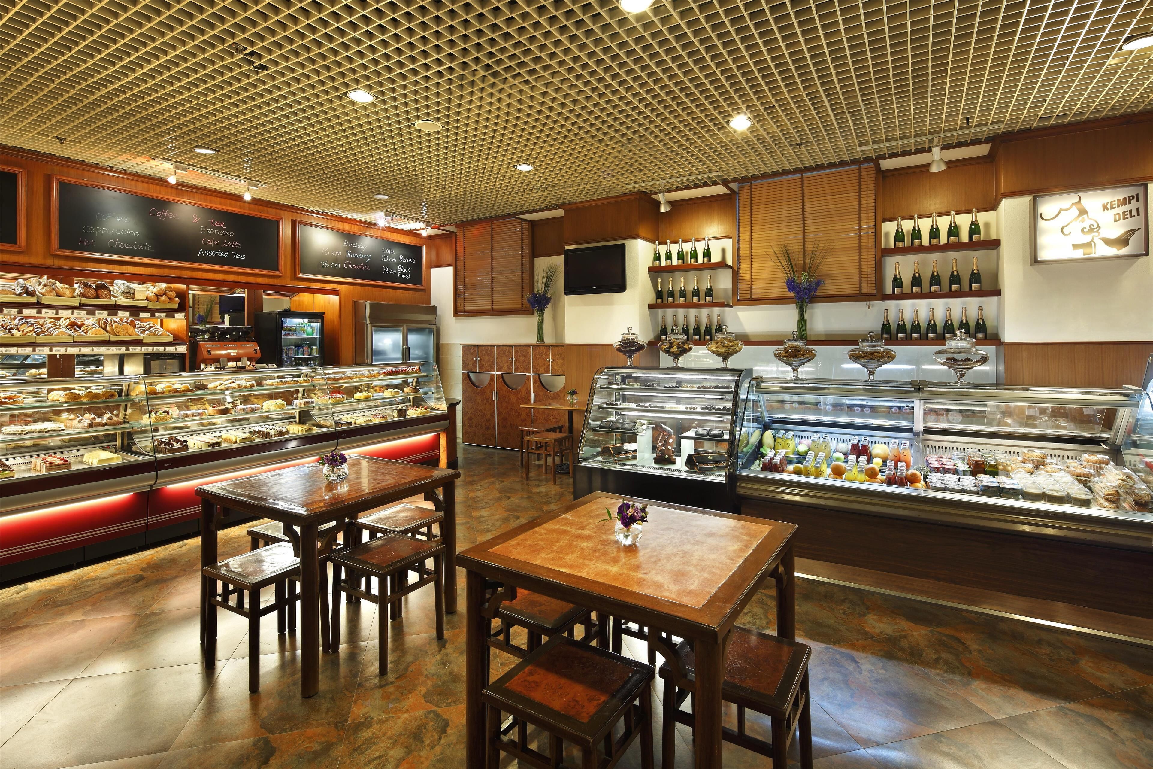 A bakery section with display cases of pastries and a selection of bottled beverages.
