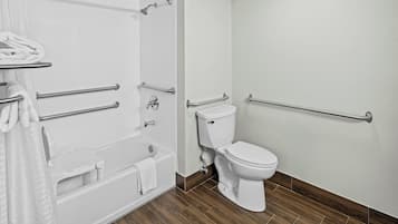 A bathroom with a bathtub, toilet, and shower.